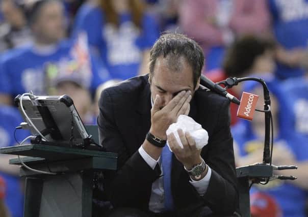 French umpire Arnaud Gabas holds his face after being struck by a ball hit by Denis Shapovalov. Picture: AP.