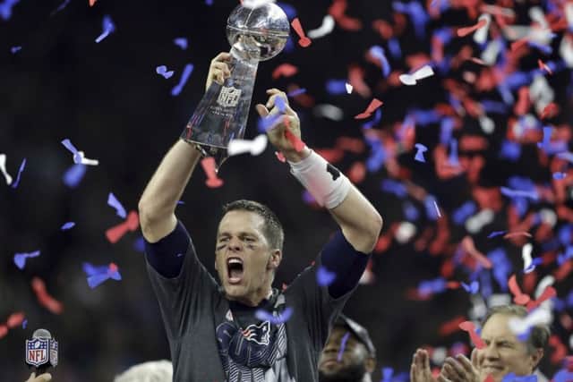 New England Patriots' Tom Brady raises the Vince Lombardi Trophy after defeating the Atlanta Falcons in overtime at the NFL Super Bowl 51 football game Sunday, Feb. 5, 2017, in Houston. The Patriots defeated the Falcons 34-28. (AP Photo/Darron Cummings)