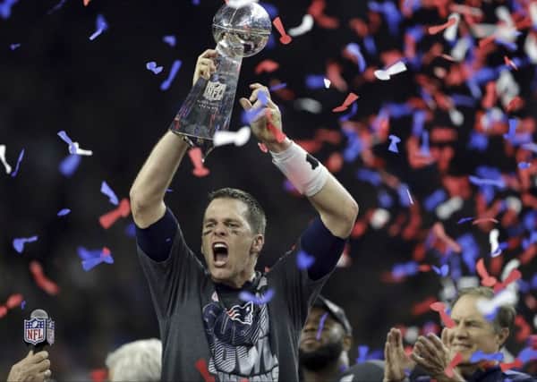 New England Patriots' Tom Brady raises the Vince Lombardi Trophy after defeating the Atlanta Falcons in overtime at the NFL Super Bowl 51 football game Sunday, Feb. 5, 2017, in Houston. The Patriots defeated the Falcons 34-28. (AP Photo/Darron Cummings)