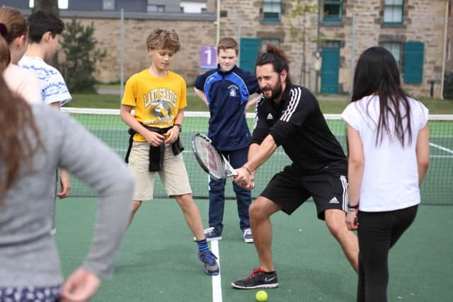 Ryan Harrower, City of Edinburghs racquets development officer, demonstrates a technique.