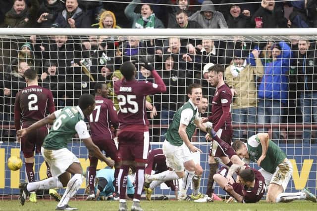 Hibs celebrate after Paul Hanlon's last-gasp equaliser against Hearts at Tynecastle last February. Picture: Greg Macvean
