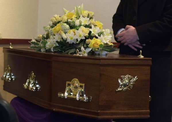PIC SANDY YOUNG for SOS Pictured Grant Nichol of Leith Funeral Service's with a coffin and flowers on top with cross in background.Part of a story on Ministers not having time to do a funeral service.
