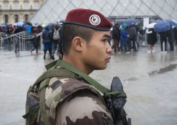 A French soldier patrols outside the Louvre museum in Paris after a machete-wielding assailant shouting "Allahu Akbar" was shot earlier this month. Picture: AP Photo/Kamil Zihnioglu