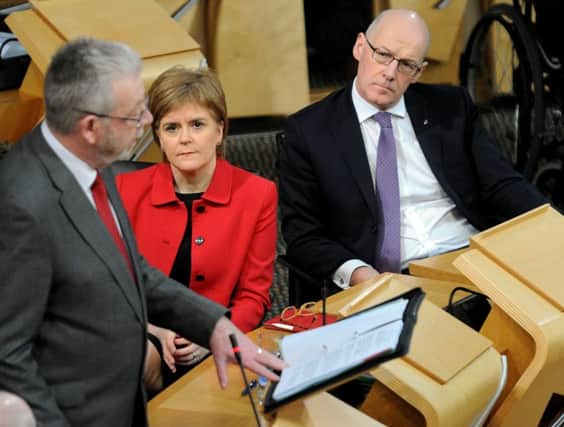 Scottish Brexit Minister Mike Russell delivers his speech in Parliament as First Minister Nicola Sturgeon looks on. Picture: Lisa Ferguson