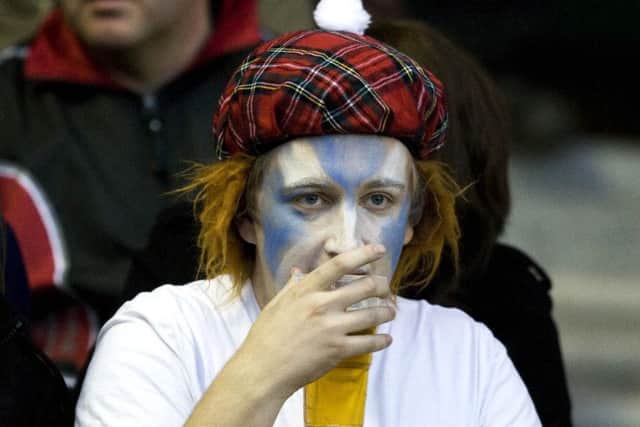 A Scotland fan enjoys a beer at a rugby international match at Murrayfield. Picture: SNS