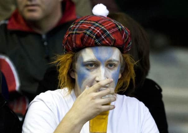 A Scotland fan enjoys a beer at a rugby international match at Murrayfield. Picture: SNS