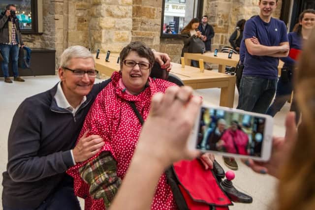 Apple boss Tim Cook meets Angela Reed at the tech firm's store in Glasgow. The CEO was in Scotland to receive an honorary doctorate of science. Picture: John Devlin/TSPL