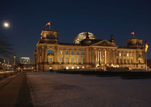 A full moon shines over the Reichstag in Berlin. Germans are among the 40 per cent of Europeans voting this year. Picture: Sean Gallup/Getty Images