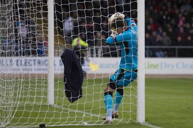 Dundee goalkeeper David Mitchell looks to cross the line with the ball during his side's 2-0 win over Motherwell earlier this season. Picture: SNS
