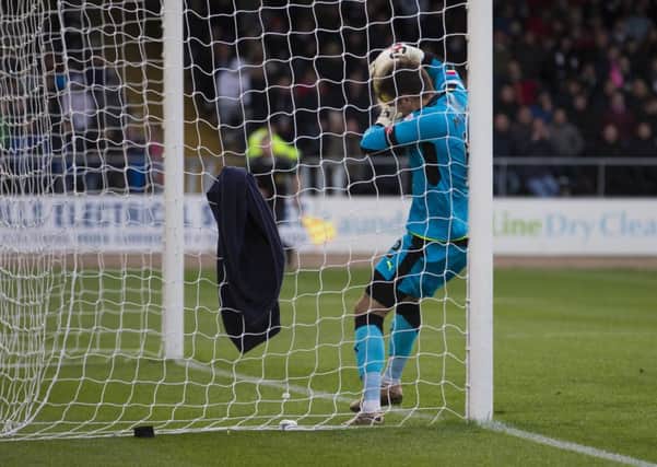Dundee goalkeeper David Mitchell looks to cross the line with the ball during his side's 2-0 win over Motherwell earlier this season. Picture: SNS