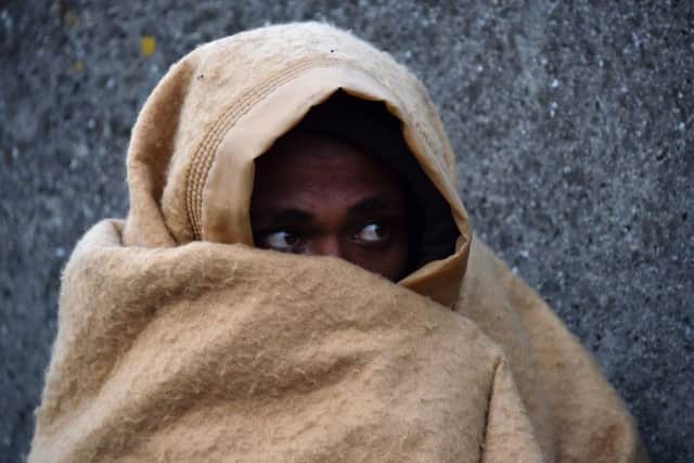 A refugee keeps warm at the camp in Calais, before its evacuation late last year. Picture: Philippe Huguen/Getty