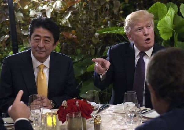 Donald Trump sits down to dinner with Japanese Prime Minister Shinzo Abe. Picture: AP