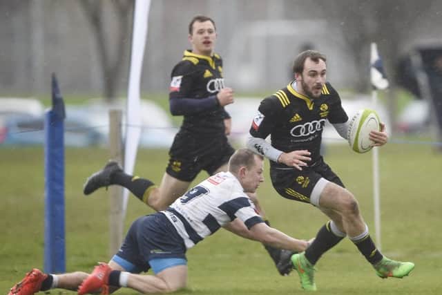 Melroses Sam Pecqueur evades the clutches of Tom Wilson as the visitors edged it.  Photograph: Greg Macvean