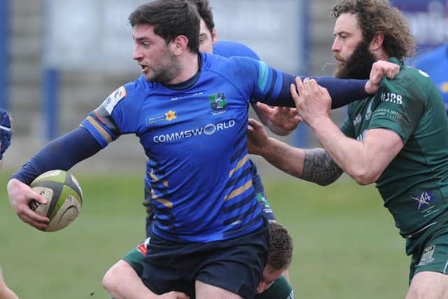 David Reekie of Muir and Hawick's Bruce McNeil. Picture:
Neil Hanna