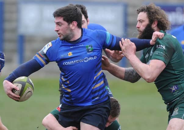 David Reekie of Muir and Hawick's Bruce McNeil. Picture:
Neil Hanna