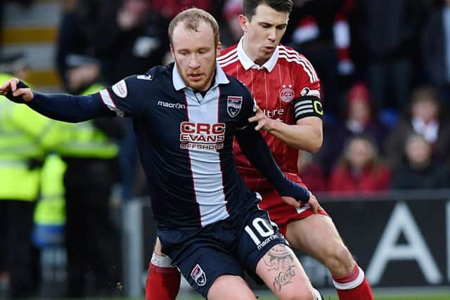 Ross County's Liam Boyce is challenged by Aberdeen's Ryan Jack. Picture: SNS.
