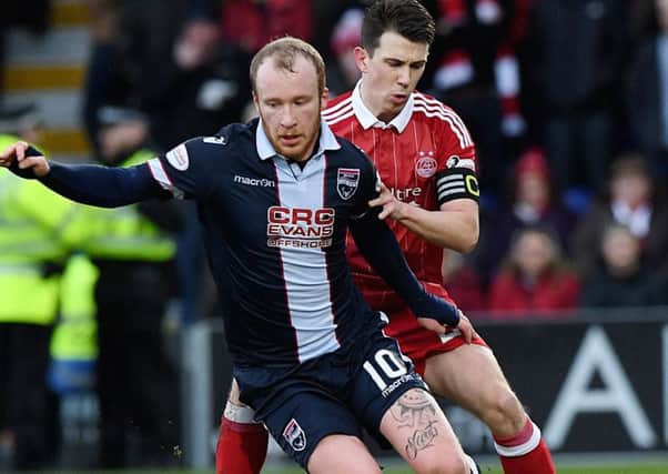 Ross County's Liam Boyce is challenged by Aberdeen's Ryan Jack. Picture: SNS.