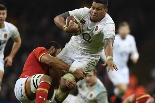 A charge by Nathan Hughes is halted by Wales Taulupe Faletau. Picture: Getty.
