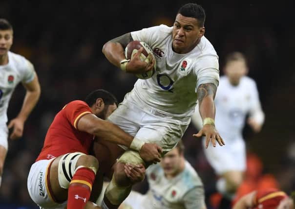 A charge by Nathan Hughes is halted by Wales Taulupe Faletau. Picture: Getty.