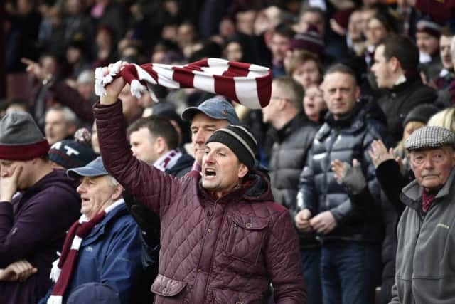 Hearts fans indulge in a bit of scarf twirling during yesterdays Tynecastle derby. Picture: SNS.