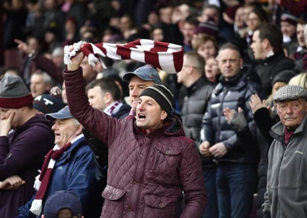 Hearts fans indulge in a bit of scarf twirling during yesterdays Tynecastle derby. Picture: SNS.