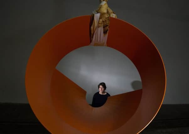 Claire Barclay with one of the sculptures in Yield Point at Tramway in Glasgow PIC: John Devlin