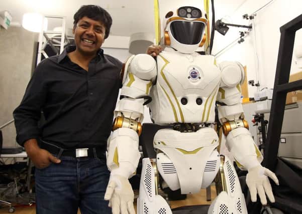 Prof Sethu Vijayakumar of Edinburgh University's Robotics dpeartment with robot Valkyrie. Picture: SWNS