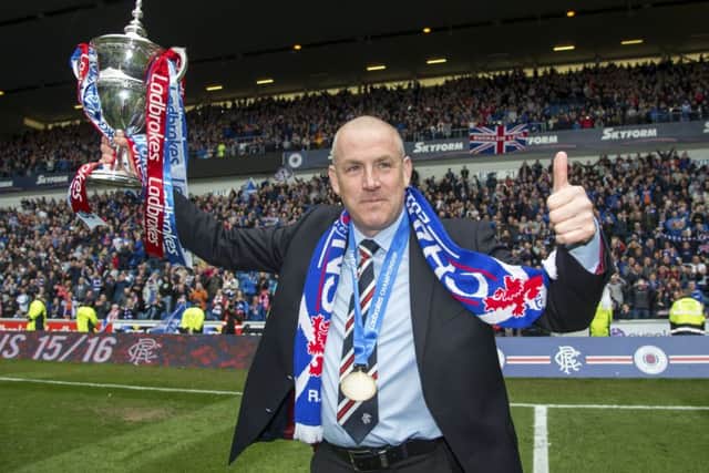 It's not the Petrofac Training Cup, but Mark Warburton looks pretty happy to have won the Ladbrokes Championship crown. Picture: SNS