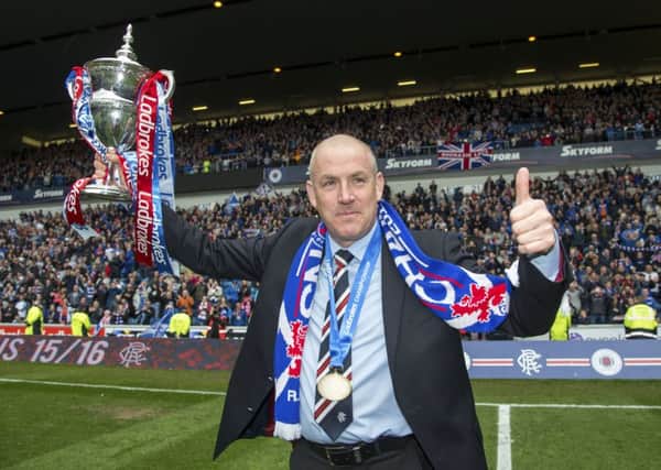 It's not the Petrofac Training Cup, but Mark Warburton looks pretty happy to have won the Ladbrokes Championship crown. Picture: SNS