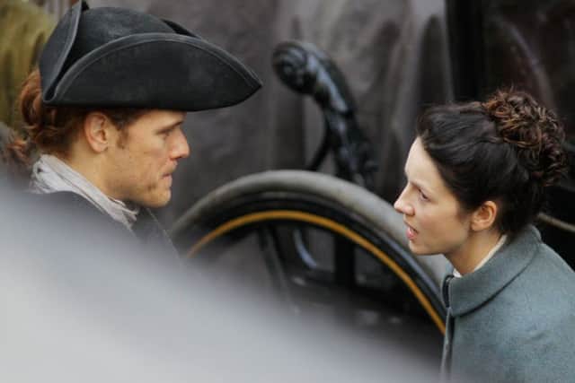 Sam Heughan and Caitriona Balfe film scenes for Outlander on the Royal Mile in Edinburgh. Picture: SWNS