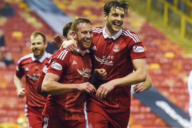 Aberdeens Adam Rooney completes his hat-trick and celebrates with Ash Taylor, right, on a night Motherwell will want to forget. Picture: Craig Williamson/SNS