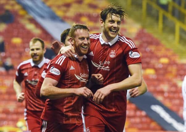 Aberdeens Adam Rooney completes his hat-trick and celebrates with Ash Taylor, right, on a night Motherwell will want to forget. Picture: Craig Williamson/SNS