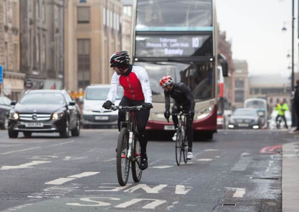 Why do cyclists have to share road space with buses? Picture: Toby Williams