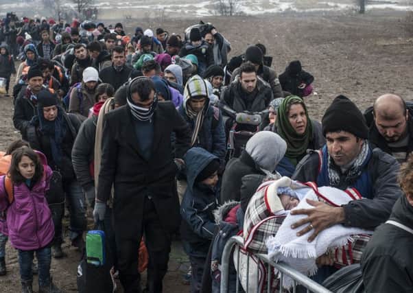 Migrants and refugees wait for security checks after crossing the Macedonian border into Serbia, a year ago. This route has now been closed off, leaving many stranded. Picture: AFP/Getty.