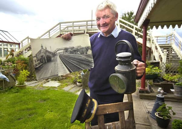 Resident Tom Pyemont with a picture of Hassendean Station as it was in its heyday. Picture: TSPL