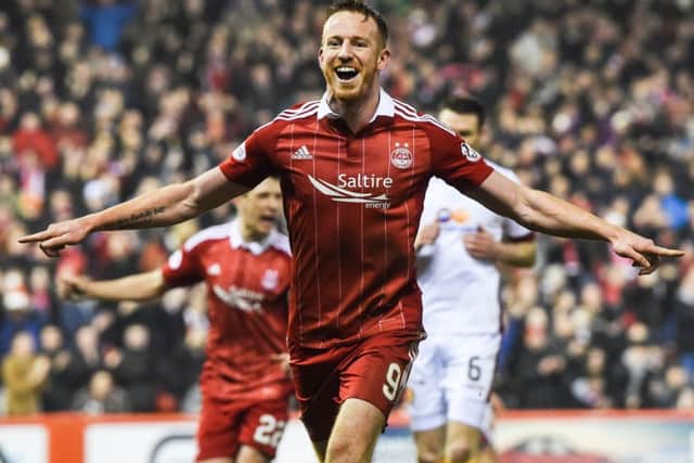 Aberdeen's Adam Rooney celebrates the second of his three goals against Motherwell. Picture: SNS