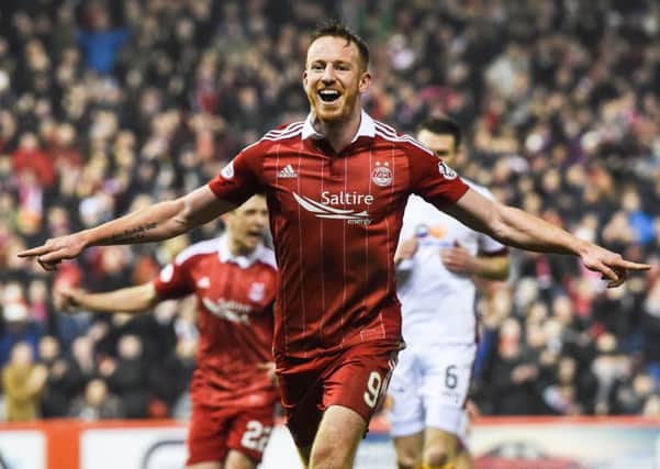 Aberdeen's Adam Rooney celebrates the second of his three goals against Motherwell. Picture: SNS