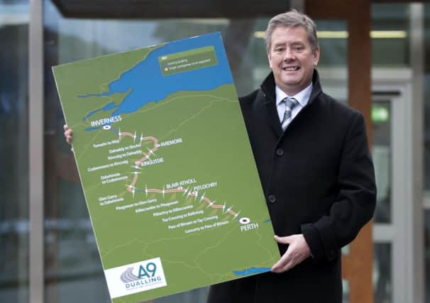 Economy secretary Keith Brown with a map of the A9 dualling project. Picture: Jane Barlow