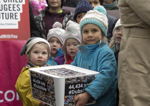Children holds a box of signed petitions. Picture: JUSTIN TALLIS/AFP/Getty Images