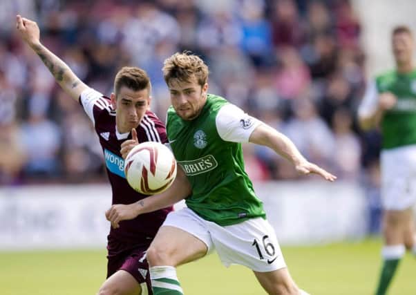 Unlike some of his team-mates, Lewis Stevenson, here clashing with Jamie Walker in 2013, has long experience of city derbies. Picture: Rob Casey/SNS