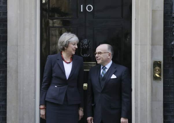 Theresa May greets French Prime Minister Bernard Cazeneuve at Downing Street. Picture: AP