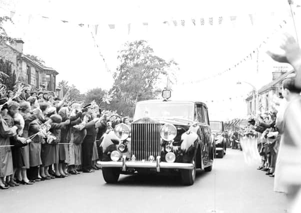The people of Kilwinning turn out to welcome the Queen and Prince Philip on their tour of Scotland in 1956. Picture: TSPL