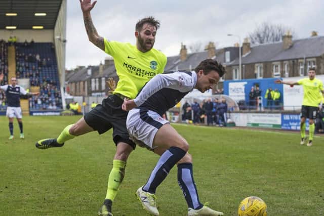 Raith Rovers' Kyle Benedictus shields the ball from Hibernian's James Keatings. Picture: SNS.