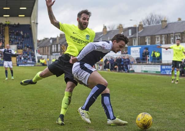 Raith Rovers'  Kyle Benedictus shields the ball from Hibernian's James Keatings. Picture: SNS.