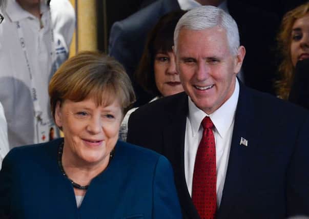 German Chancellor Angela Merkel and US vice-president Mike Pence arrive at the Munich Security Conference yesterday. Picture: AFP/Thomas Kienzle/Getty Images.