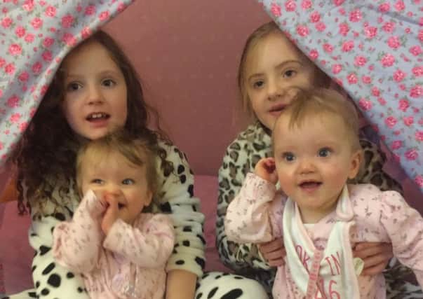 Identical twins Leah and Erin with their older sisters Charlotte and Isabelle. Picture: SWNS