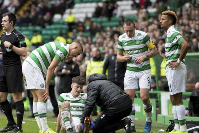 Kieran Tierney receives treatment after Ryan Bowmans tackle. Picture: SNS.