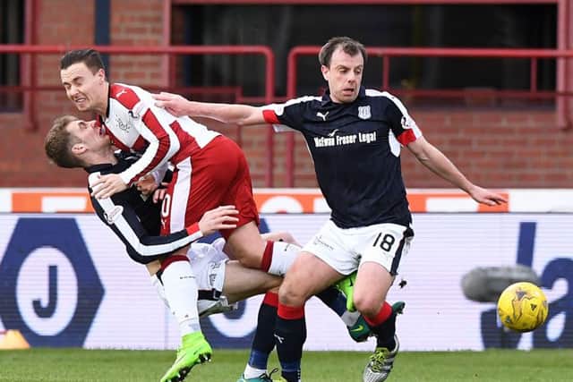 Paul McGowan comes away with the ball as Rangers Barrie McKay collides with Kevin Holt. Picture: SNS