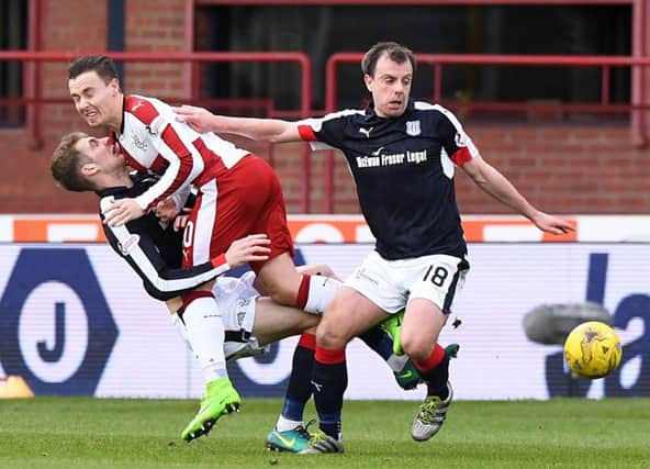 Paul McGowan comes away with the ball as Rangers Barrie McKay collides with Kevin Holt. Picture: SNS
