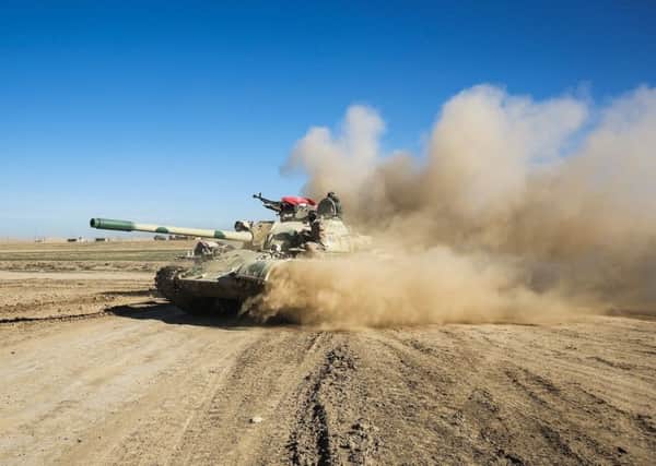 Tanks and armoured vehicles of the Iraqi forces, supported by the Hashed al-Shaabi paramilitaries, advance towards the village of Sheikh Younis, south of Mosul, after the offensive to retake the western side of Mosul from Islamic State (IS) group fighters commenced. Picture AFP/Getty Images